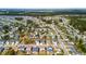Aerial view of home in residential neighborhood with tree lined streets and pond at 404 Ambergate Ln, Moncks Corner, SC 29461