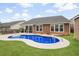 This backyard features a beautiful kidney shaped pool, patio area and well-maintained lawn at 404 Ambergate Ln, Moncks Corner, SC 29461