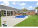 Backyard with swimming pool, patio, green lawn, and brown wood panel siding at 404 Ambergate Ln, Moncks Corner, SC 29461