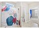 Bright bathroom with a patterned shower curtain and a glimpse into an adjacent blue-walled bedroom at 404 Ambergate Ln, Moncks Corner, SC 29461