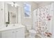 Bright bathroom features a single sink vanity, floral shower curtain, and neutral wall color at 404 Ambergate Ln, Moncks Corner, SC 29461