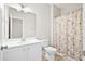 Bright bathroom with a vanity, toilet, and a shower with a floral-patterned curtain at 404 Ambergate Ln, Moncks Corner, SC 29461
