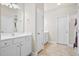 Well-lit bathroom featuring white cabinetry, double sinks, and a clean, functional layout at 404 Ambergate Ln, Moncks Corner, SC 29461