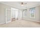 Spacious bedroom with French doors, plush carpeting, and ample natural light from large windows at 404 Ambergate Ln, Moncks Corner, SC 29461