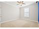 Cozy bedroom featuring neutral walls, plush carpeting, ceiling fan, and a window at 404 Ambergate Ln, Moncks Corner, SC 29461