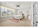 Spacious bedroom featuring plush carpeting, a ceiling fan, and lots of natural light from large windows at 404 Ambergate Ln, Moncks Corner, SC 29461