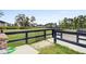 Dog park area behind fence with grassy area and homes in the distance, creating a serene and safe place at 404 Ambergate Ln, Moncks Corner, SC 29461