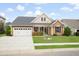 Charming single story home featuring well-manicured lawn, landscaping, covered porch, and two car garage at 404 Ambergate Ln, Moncks Corner, SC 29461