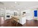 A spacious kitchen with hardwood floors, an island with seating, stainless steel appliances, and white cabinetry at 404 Ambergate Ln, Moncks Corner, SC 29461