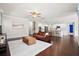 Bright living room with hardwood floors, white area rug, and a seamless flow into the kitchen at 404 Ambergate Ln, Moncks Corner, SC 29461