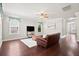 Cozy living room with hardwood floors, ceiling fan, and a tranquil view through the windows at 404 Ambergate Ln, Moncks Corner, SC 29461
