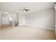 Expansive loft area with neutral carpeting, ceiling fan, and multiple entryways at 404 Ambergate Ln, Moncks Corner, SC 29461