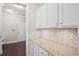 This walk-in pantry features granite countertops, bright white cabinetry and a neutral paint color at 404 Ambergate Ln, Moncks Corner, SC 29461