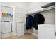 Organized walk-in closet with built-in shelves and a laundry area with washer and dryer included at 404 Ambergate Ln, Moncks Corner, SC 29461