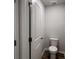 Half-bathroom featuring a toilet and wooden look flooring at 405 Mistflower Ln, Moncks Corner, SC 29461