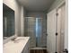Well-lit bathroom with sink vanity, glass door shower, and wood-look flooring at 405 Mistflower Ln, Moncks Corner, SC 29461