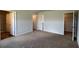 Spacious bedroom featuring neutral colors, carpet flooring, and doors to closet and bathroom at 405 Mistflower Ln, Moncks Corner, SC 29461