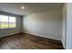 Bedroom featuring a large window for natural light and wood floors at 405 Mistflower Ln, Moncks Corner, SC 29461