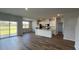 Bright kitchen with an island, stainless appliances, and sliding glass doors to outdoor space at 405 Mistflower Ln, Moncks Corner, SC 29461