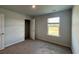 Bright bedroom with plush carpeting, large window, and closet at 407 Mistflower Ln, Moncks Corner, SC 29461