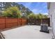 Enclosed backyard with privacy fence, concrete patio with seating and a modern air conditioning unit at 4120 Veritas St, Charleston, SC 29414