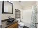 Stylish bathroom with a vessel sink, granite countertop, and tub with shower at 4120 Veritas St, Charleston, SC 29414