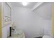 A white walled bathroom with a glass bowl sink, commode and three pronged coat rack at 4120 Veritas St, Charleston, SC 29414