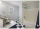 Bright bathroom features double bowl sinks and a shower-tub with checkered flooring at 4120 Veritas St, Charleston, SC 29414