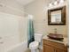 Bathroom featuring granite counters, a decorative sink, tile floors and a tub-shower combo at 4120 Veritas St, Charleston, SC 29414