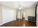 Bright bedroom with hardwood floors, ceiling fan, and access to an ensuite bathroom at 4120 Veritas St, Charleston, SC 29414