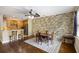 Inviting dining area featuring wood flooring, a stone accent wall, and a stylish ceiling fan, perfect for gatherings at 4120 Veritas St, Charleston, SC 29414