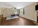 Charming dining area with wood floors, a stone accent wall, and a view of the fireplace with mounted television at 4120 Veritas St, Charleston, SC 29414