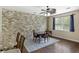 Inviting dining room with stylish accent wall, modern ceiling fan, and wood flooring at 4120 Veritas St, Charleston, SC 29414