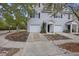 Lovely townhome showcasing a one-car garage, black shutters, and meticulous landscaping leading to the front entrance at 4120 Veritas St, Charleston, SC 29414