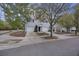 Charming townhome featuring light gray siding, a one-car garage, and a well-manicured lawn with mature trees at 4120 Veritas St, Charleston, SC 29414