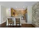 Modern kitchen with wooden cabinetry, granite countertops, and stainless steel appliances with barstool seating at 4120 Veritas St, Charleston, SC 29414
