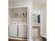 Convenient laundry room closet with washer and dryer, complete with storage shelves for supplies at 4120 Veritas St, Charleston, SC 29414