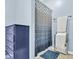This bathroom features blue walls, and a blue geometric shower curtain at 45 Sycamore Ave # 116, Charleston, SC 29407
