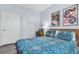 This bedroom features hardwood floors, two closets, and blue decorative bedspread at 45 Sycamore Ave # 116, Charleston, SC 29407