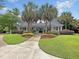 Inviting clubhouse with palm trees, colorful landscaping, and a welcoming entrance at 45 Sycamore Ave # 116, Charleston, SC 29407