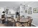 Elegant dining area featuring hardwood floors, modern lighting, and a view of the adjacent kitchen space at 45 Sycamore Ave # 116, Charleston, SC 29407