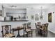 Cozy dining area with hardwood floors and stylish furnishings, adjacent to the kitchen with stainless appliances at 45 Sycamore Ave # 116, Charleston, SC 29407