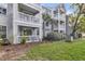 Building with multi-level balconies, showing exterior architectural details and landscaping at 45 Sycamore Ave # 116, Charleston, SC 29407