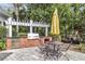 Outdoor grilling area with a built-in grill, table, and chairs for barbecues at 45 Sycamore Ave # 116, Charleston, SC 29407