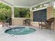 Hot tub with water feature, chairs, a roof, and views of lush landscaping at 45 Sycamore Ave # 116, Charleston, SC 29407