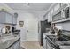 Well-equipped kitchen with granite countertops, modern appliances, and ample cabinet space for storage at 45 Sycamore Ave # 116, Charleston, SC 29407