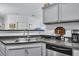 Functional kitchen area with granite countertops, stainless steel appliances, and neutral cabinetry at 45 Sycamore Ave # 116, Charleston, SC 29407