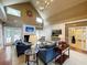 Bright living room featuring blue sofas, a fireplace, and a vaulted ceiling with elegant chandelier at 45 Sycamore Ave # 116, Charleston, SC 29407