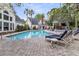 Community pool area with lounge chairs and well-maintained surroundings for residents to enjoy at 45 Sycamore Ave # 116, Charleston, SC 29407