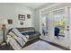 The room features a futon with blanket, and glass doors that lead to the back patio at 45 Sycamore Ave # 116, Charleston, SC 29407